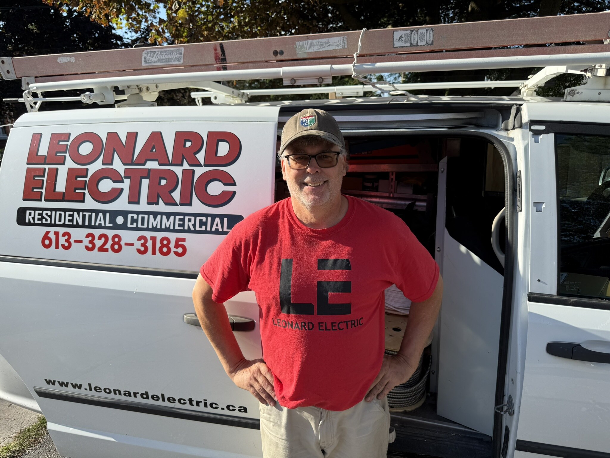 Mark Leonard standing in front of a Leonard Electric service van